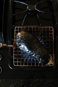 roasting baingan for baingan bharta