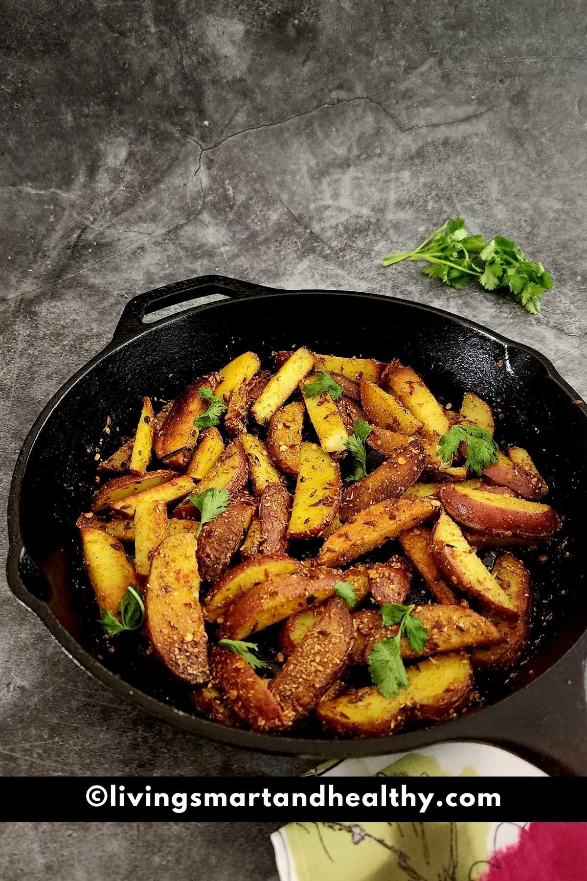 aloo bhujia (potato stir-fry) served in a cast iron skillet