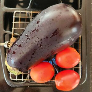 roasting baingan, tomatoes and garlic