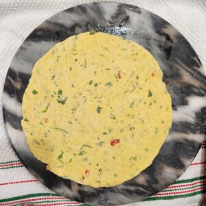 roll the dough into round paratha
