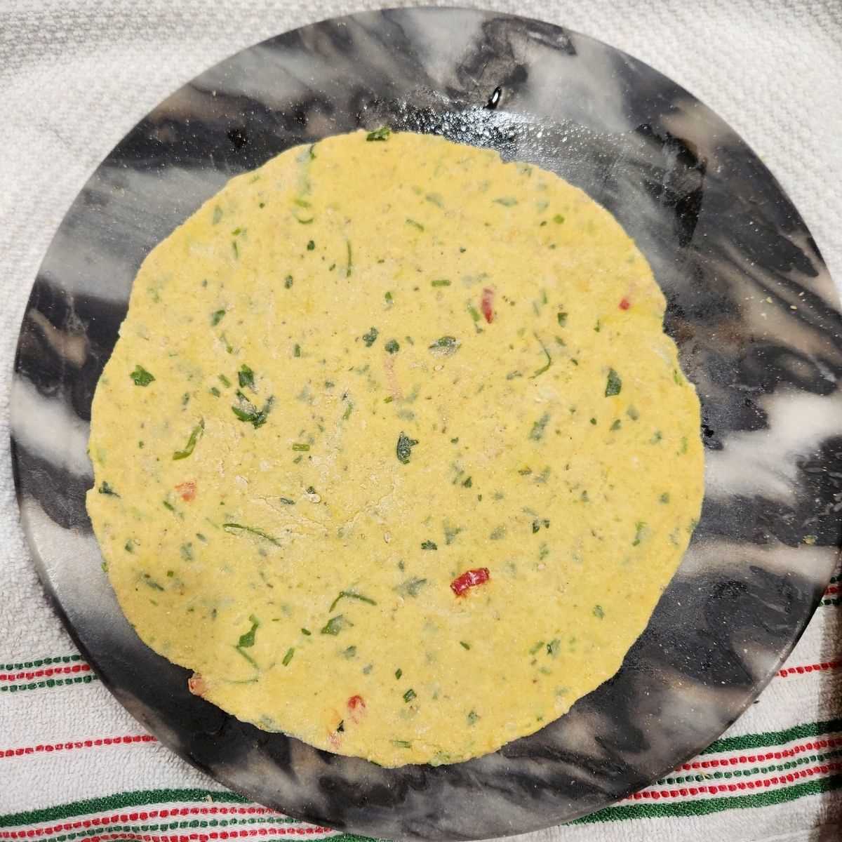 roll the dough into round paratha