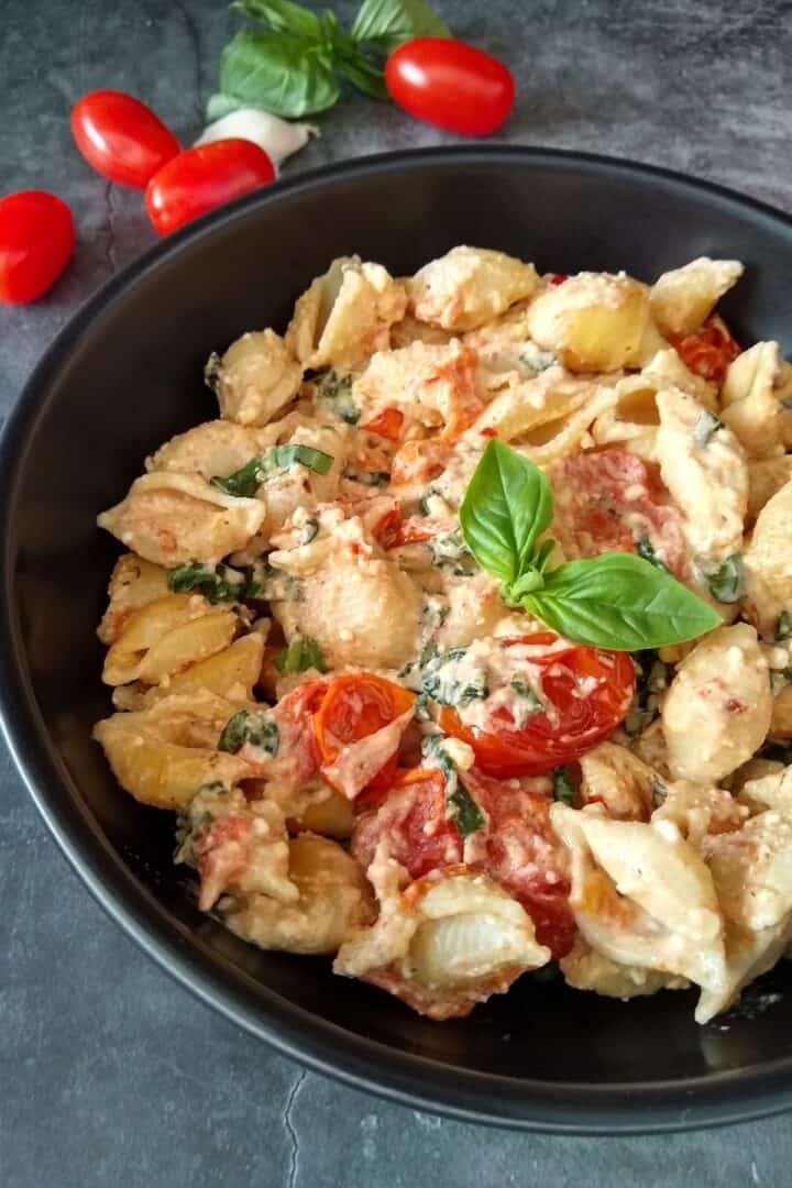 tiktok baked feta pasta garnished with fresh basil