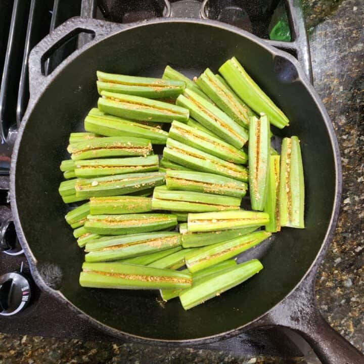 stuffed okra ready to cook in lodge cast iron skillet