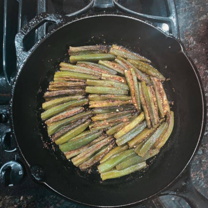 cooking bharwa bhindi in cast iron skillet