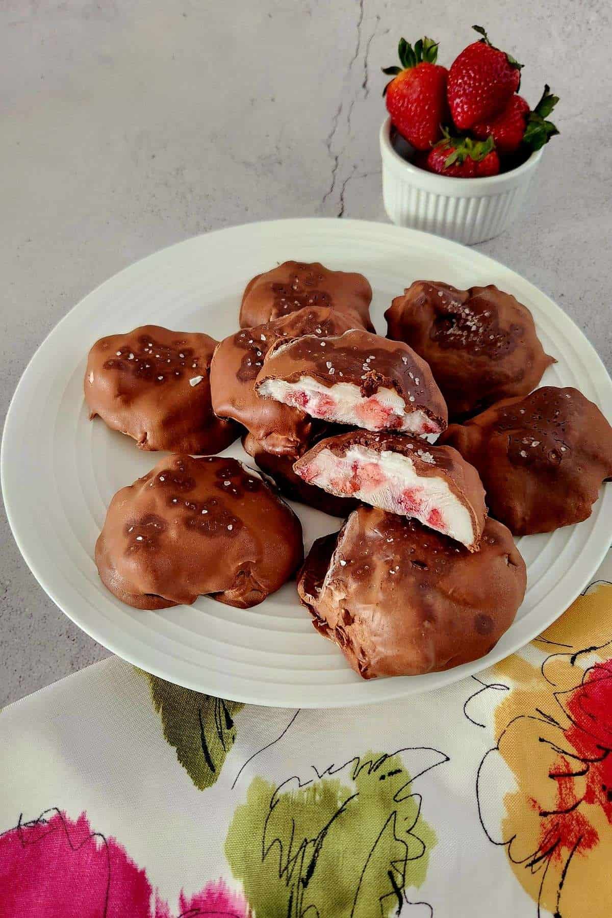 chocolate covered strawberry yogurt clusters in a white serving plate