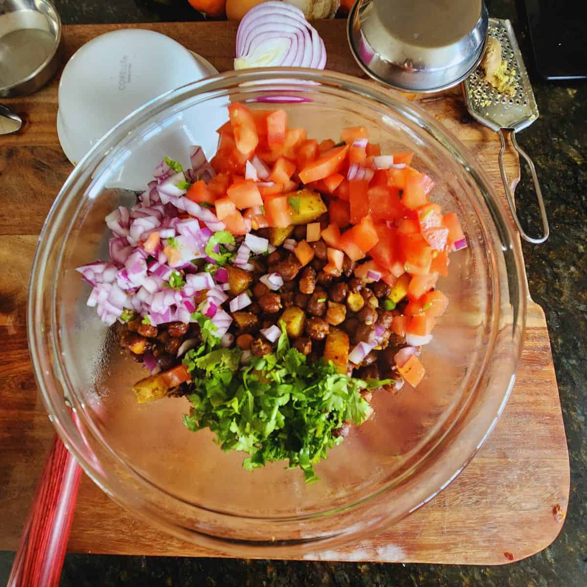 add the onions, tomatoes, coriander to kala chana chaat
