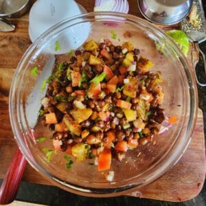 mix spiced kala chana chaat, along with fresh veggies, lemon juice and serve