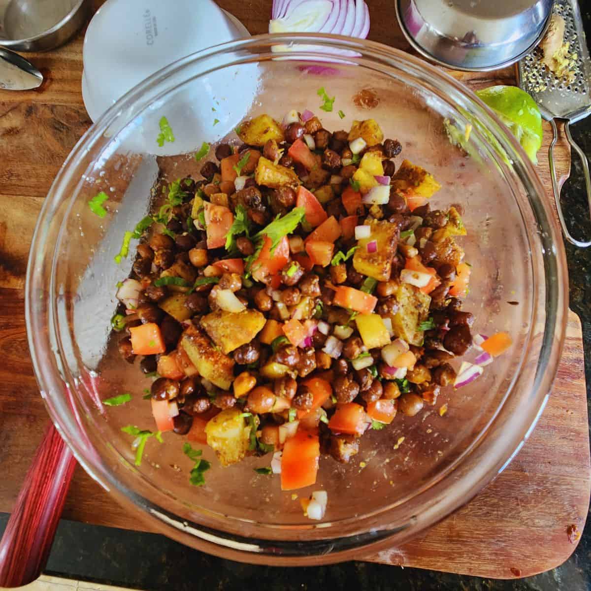 mix spiced kala chana chaat, along with fresh veggies, lemon juice and serve