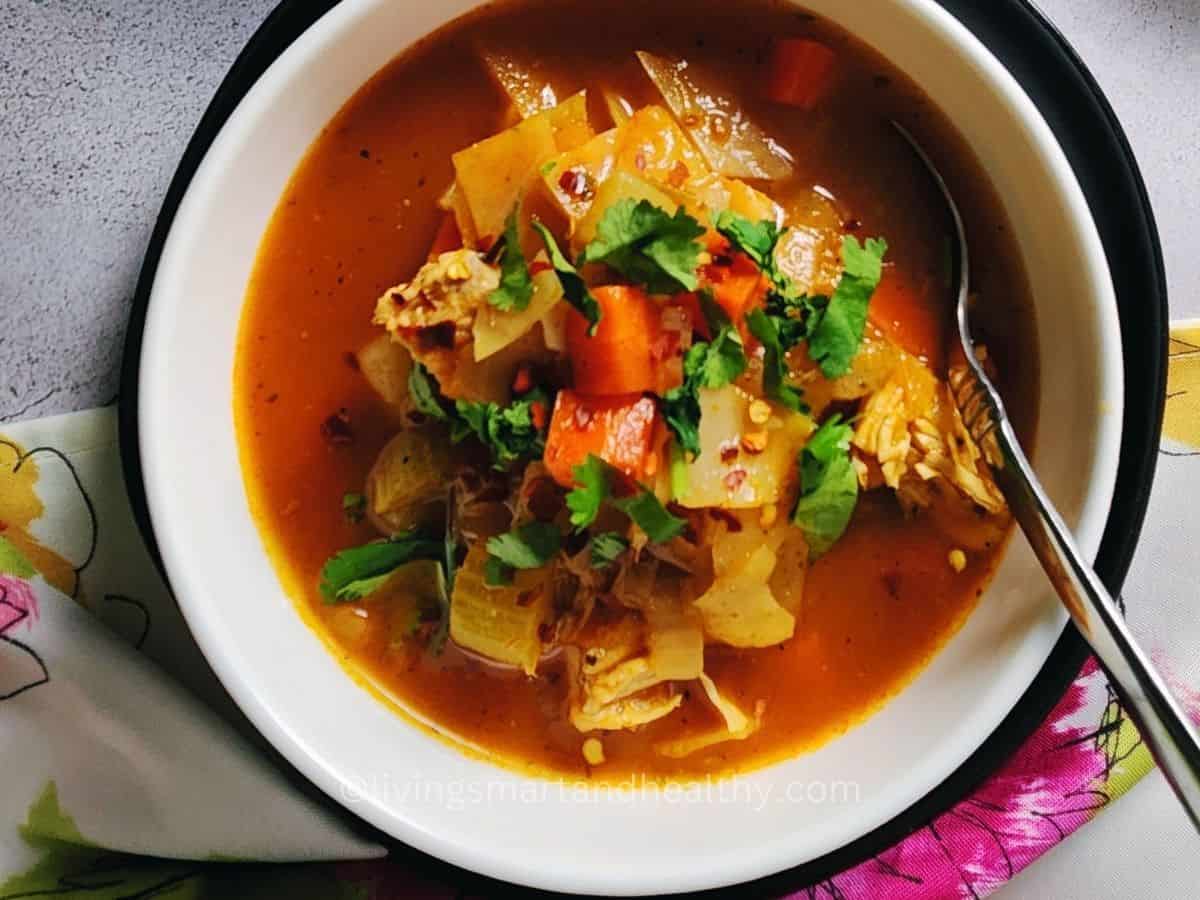 Ingredients for chicken and cabbage soup arranged on a kitchen counter