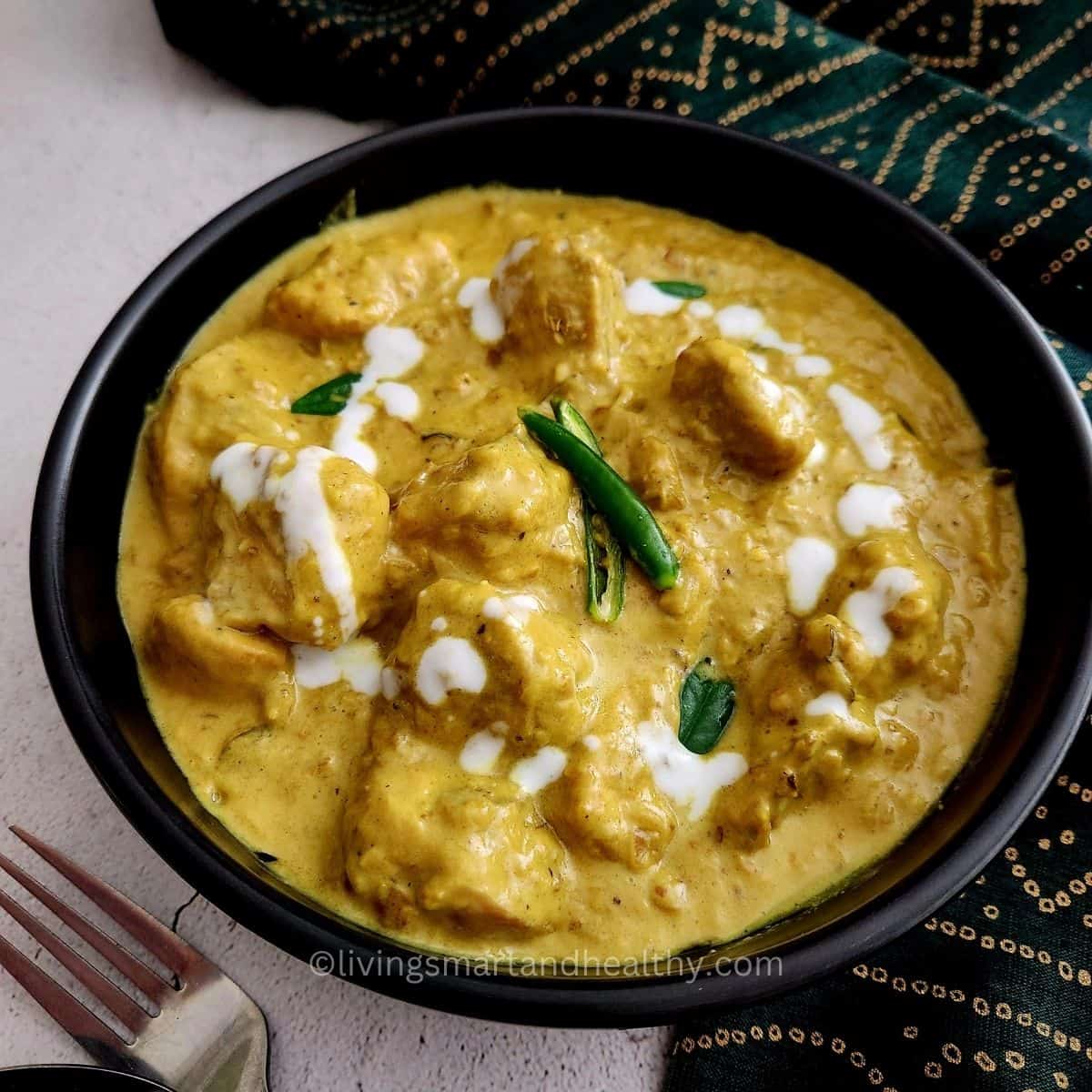 Creamy coconut chicken curry served with rice and fresh cilantro garnish