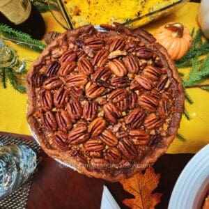 Whole maple pecan pie fresh from the oven, golden crust and gooey maple filling