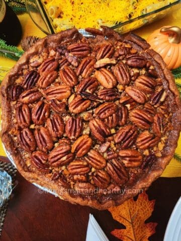 Whole maple pecan pie fresh from the oven, golden crust and gooey maple filling
