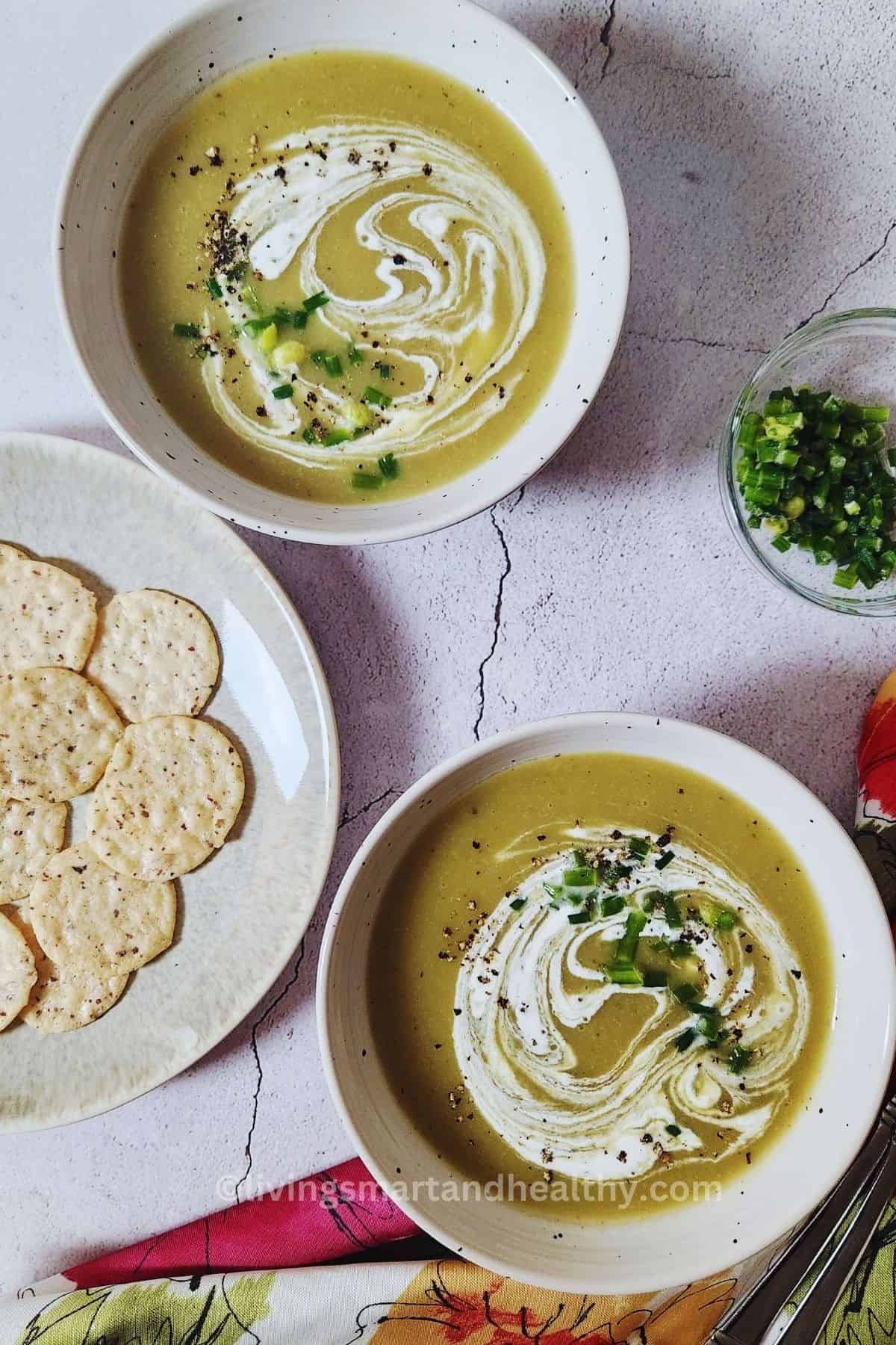 Healthy low carb celery soup served with fresh herbs and a spoon