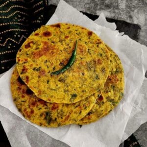 Close-up of soft bathua paratha highlighting green leafy texture
