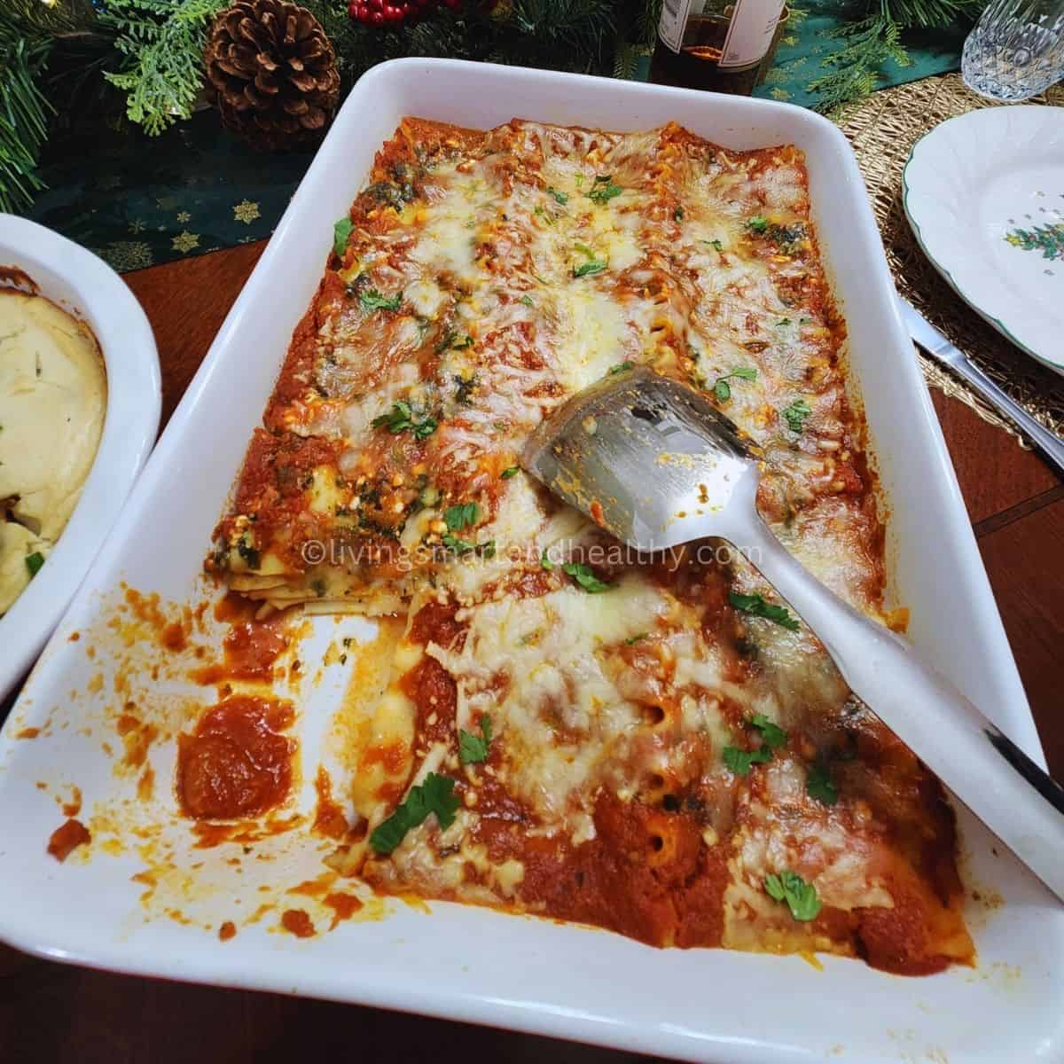 Layering process of spinach lasagna recipe with noodles, cheese-spinach filling, and marinara sauce