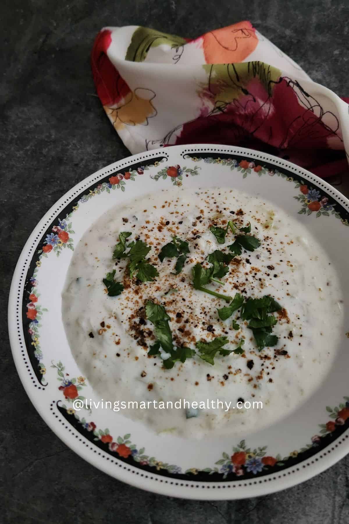 Close-up of creamy dudhi raita garnished with coriander and cumin powder