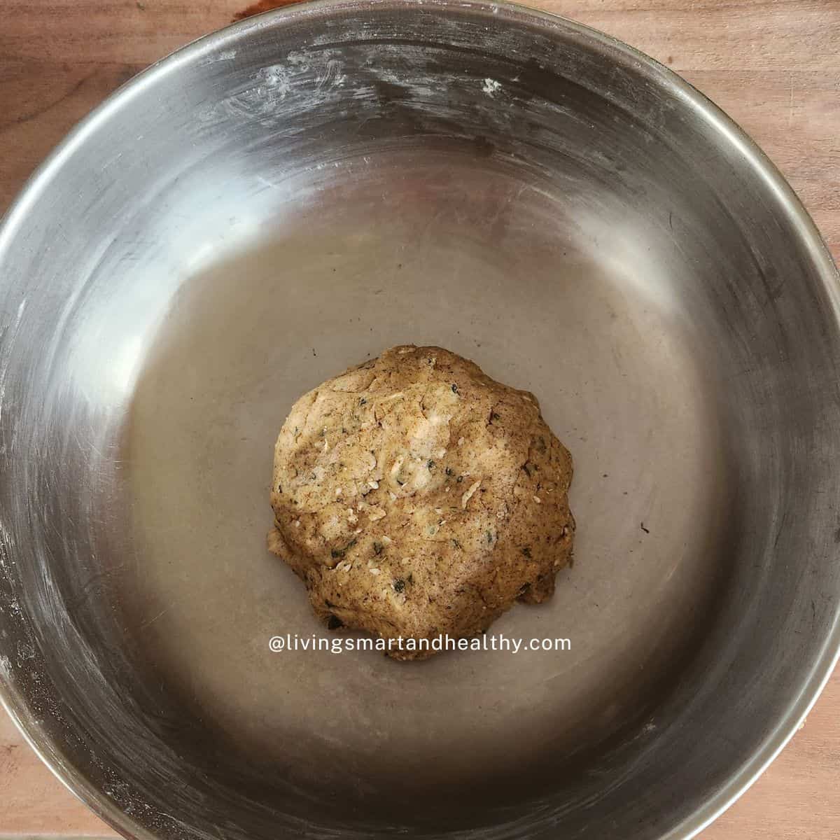 Firm and stiff methi mathri dough being kneaded in a mixing bowl, ready for air fryer mathri preparation.