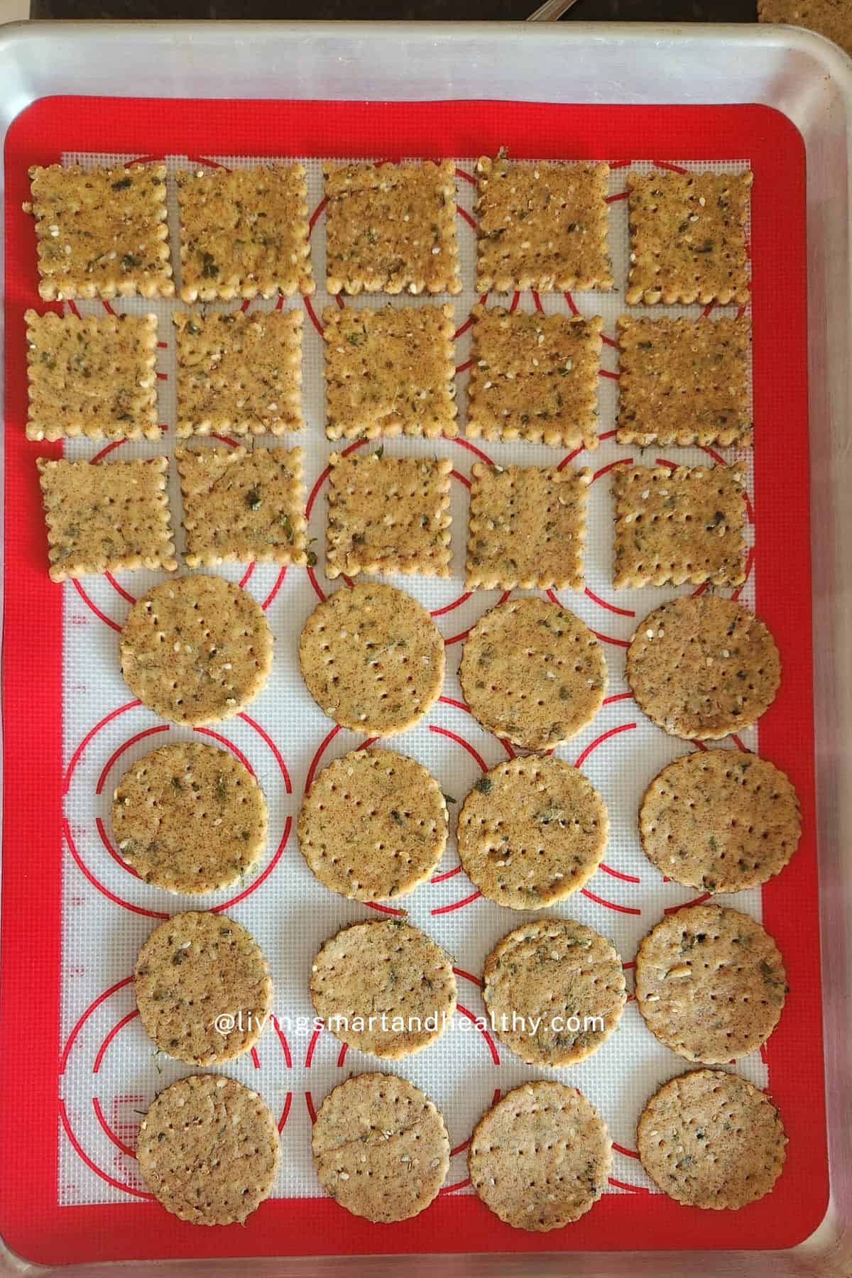 Methi mathri placed on a parchment-lined baking tray ready to bake in the oven.