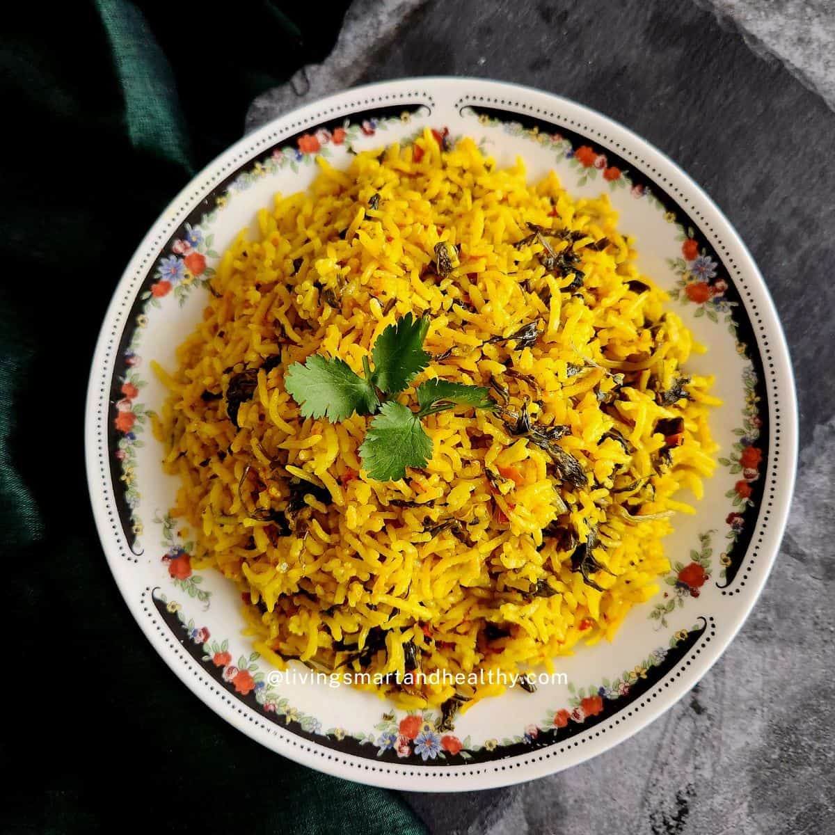 Healthy vegan Sindhi Methi Pulao plated with yogurt and papad on the side