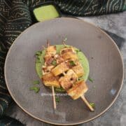 Crispy paneer and sweet potato skewers served with vrat green chutney