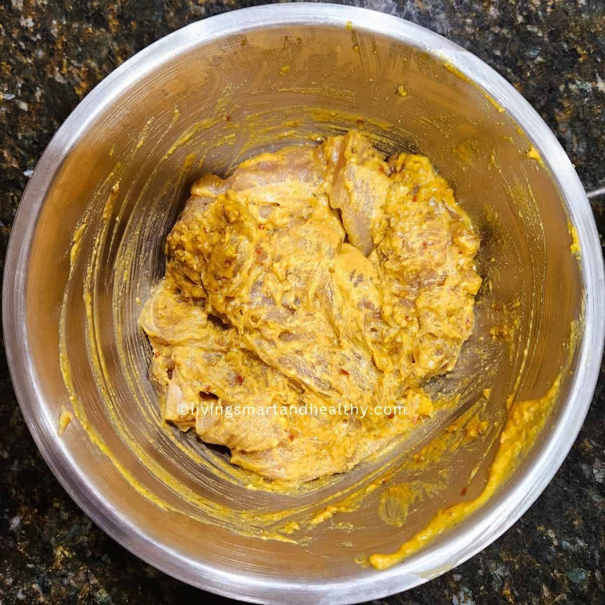 Raw marinated chicken coated in spiced batter