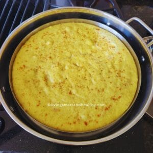 Steamed dalia dhokla garnished with coriander and coconut