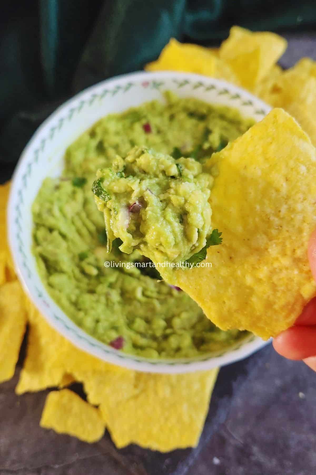 Creamy guacamole dip made with ripe avocados, onion, tomato, and cilantro