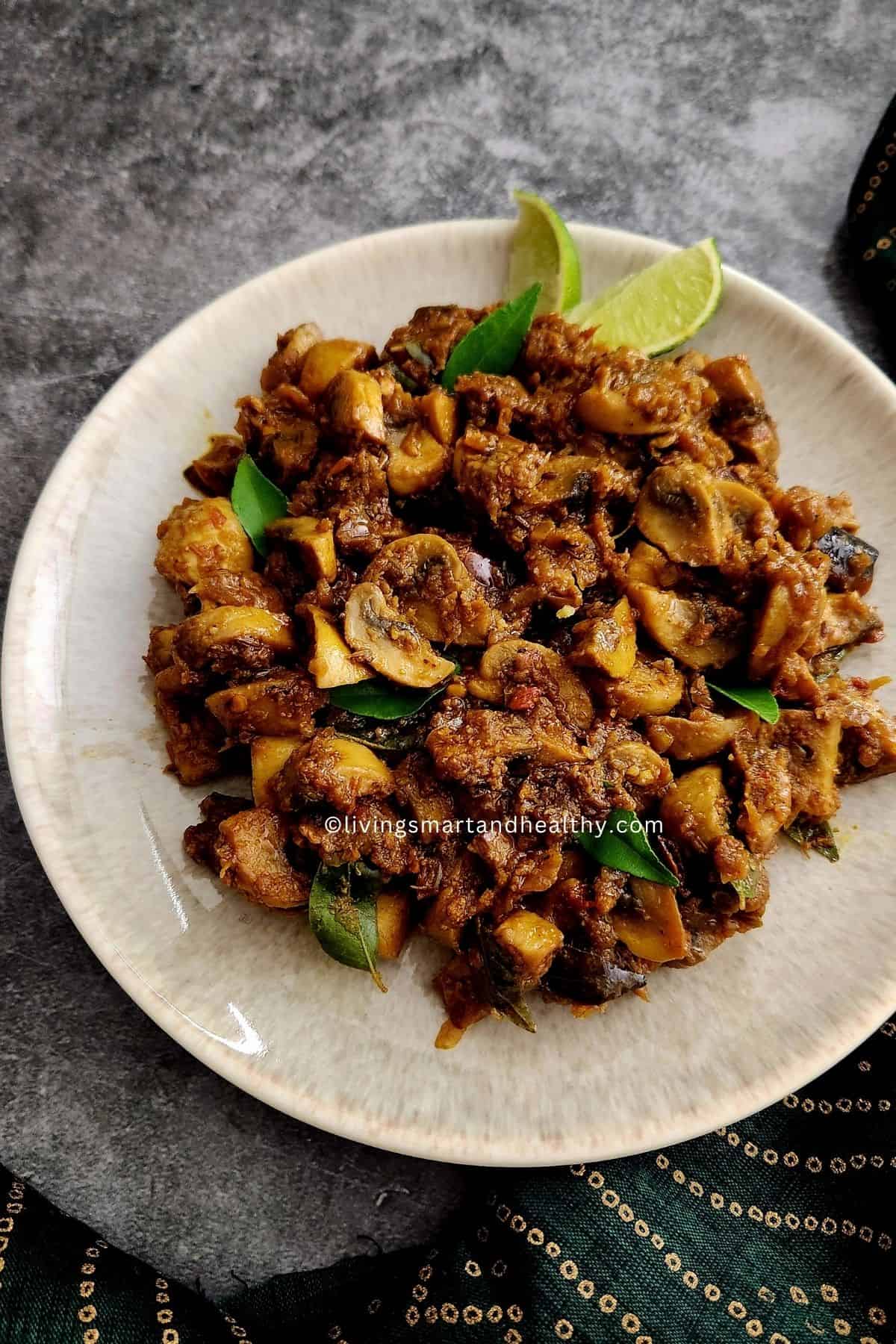 Close-up of dry mushroom stir fry with golden onions, curry leaves, and coarsely cracked pepper