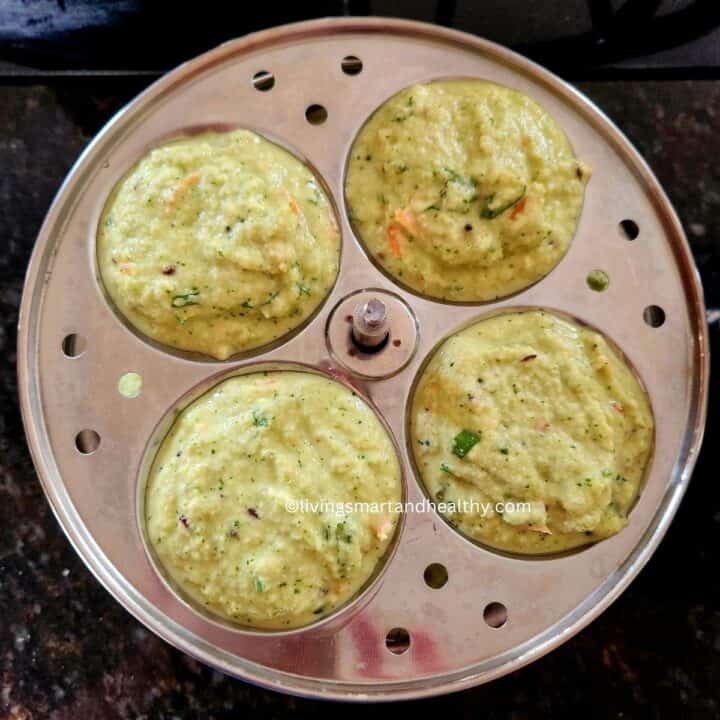 add idli batter to the greased idli mold
