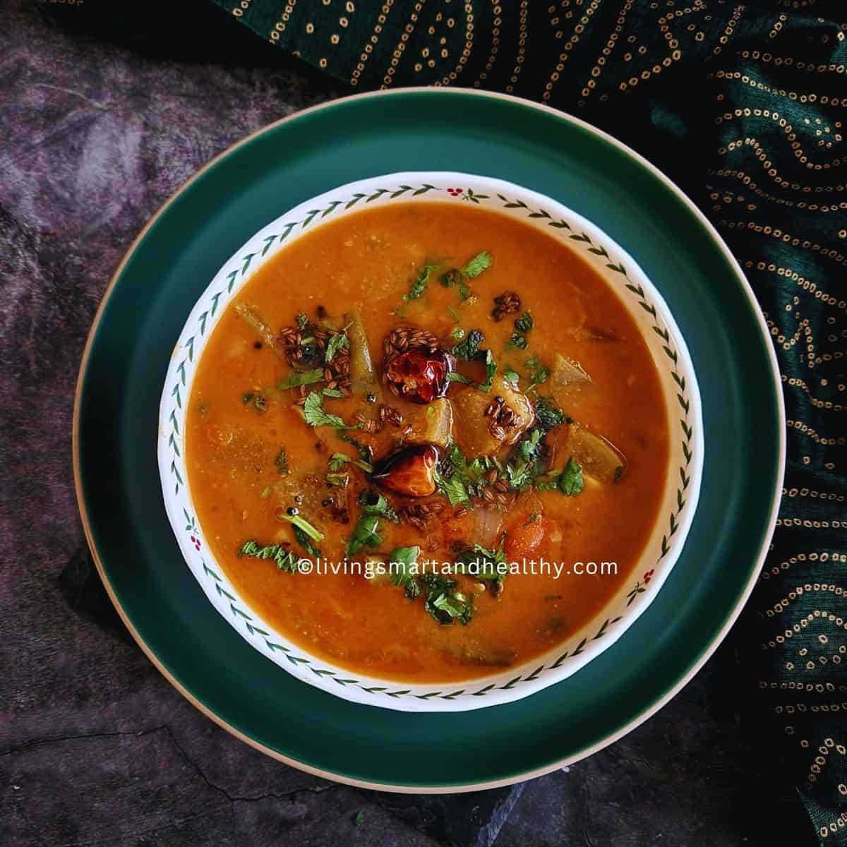 South Indian sambar served with idli and coconut chutney on a banana leaf plate