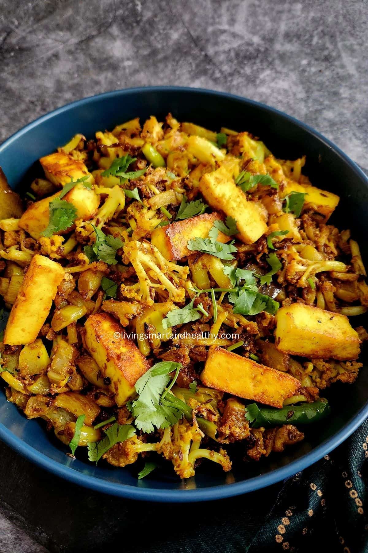 Cauliflower florets tossed in turmeric and red chili spiced mustard oil in a kadai