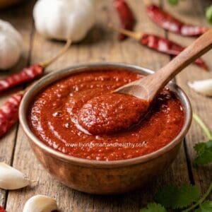 1. Homemade red chutney served in a bowl, an easy garlic chutney for dabeli, vada pav, and Indian chaats.