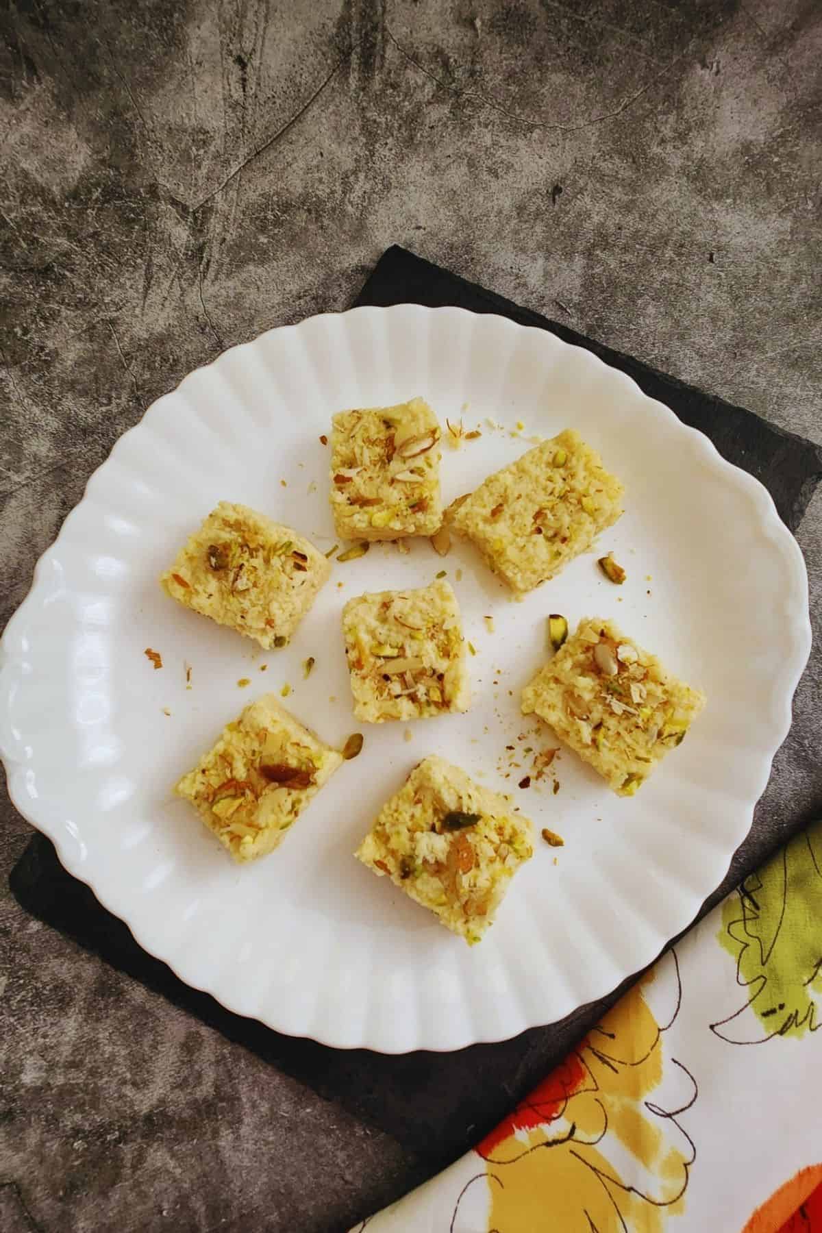 Cut pieces of kalakand arranged in mini cupcake liners